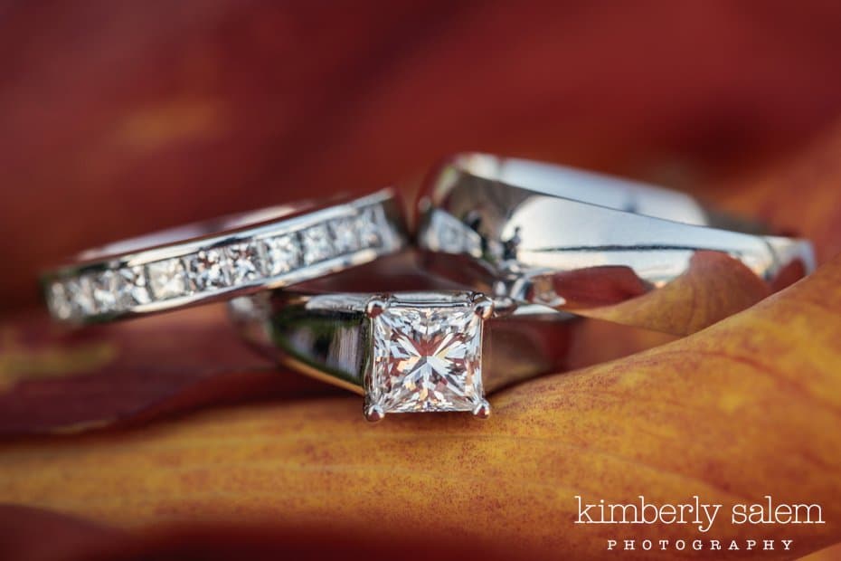 engagement ring and wedding rings together inside orange calla lily