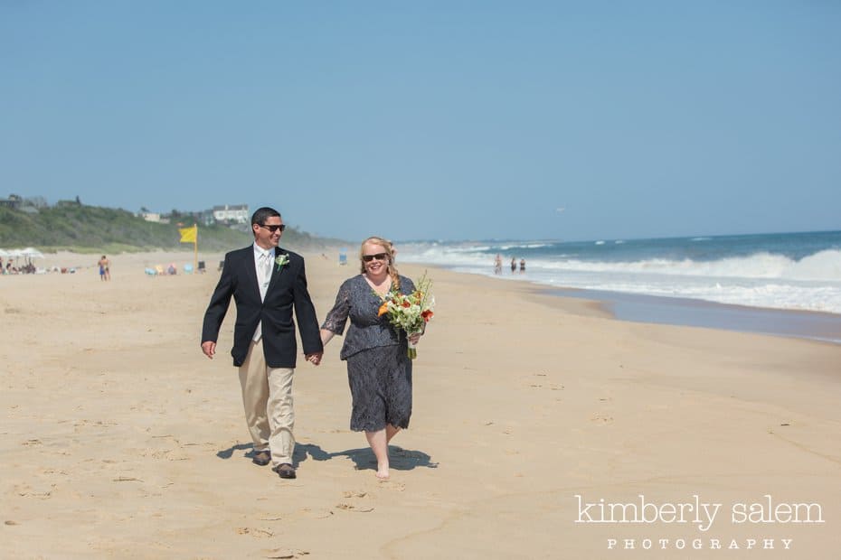 bride and groom walking on the beach at Montauk