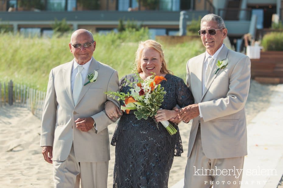 bride being escorted down the aisle during ceremony