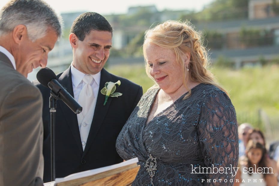 bride and groom laugh during ceremony