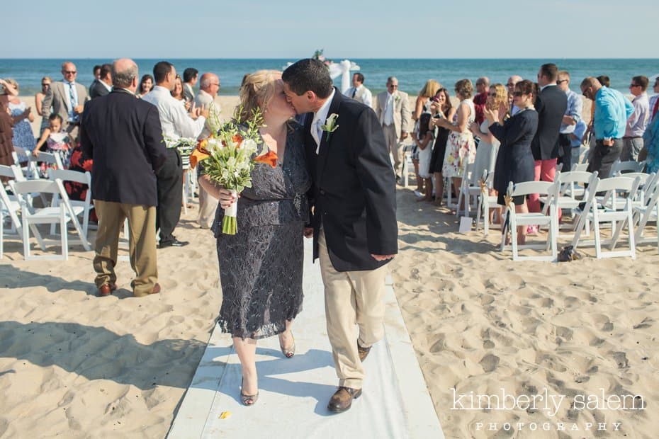 bride and groom kiss after beach wedding ceremony at Montauk