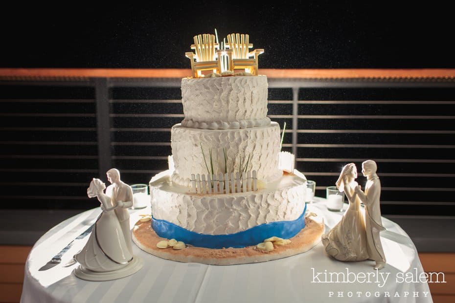 beach themed wedding cake with parents' cake toppers on either side