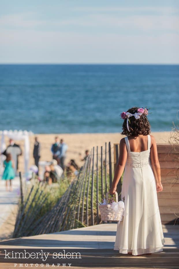 flower girl getting ready to walk down the aisle on the beach