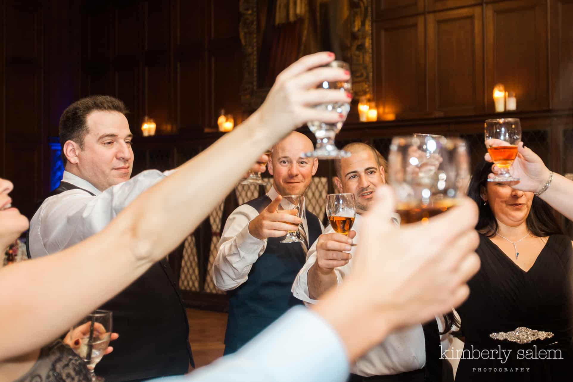 wedding guests taking a shot with the groom at Reid Castle